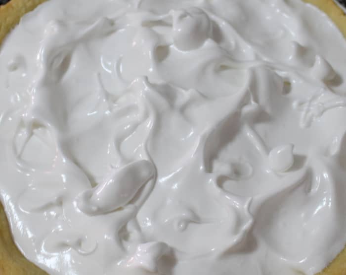 Top with meringue; meet the crust all the way around and your meringue won't sink away from the pasty