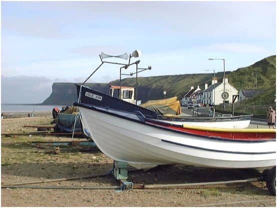 Inshore fishing vessels on Saltburn seafront looking towards Huntcliffe past Old Saltburn (the Ship Inn is the nearesr building with the white end wall