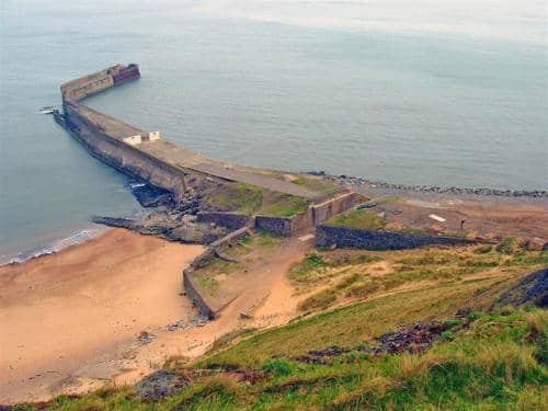 Skinningrove Jetty, once a loading point for locally mined ironstone, now a mecca for sea anglers - the name of the village stems from the Old Norse 'Shining Grove', a place of pagan worship
