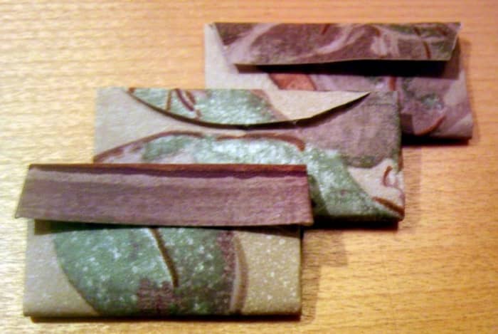 Change the style of flap by cutting a design into it. Here are three different styles. (Even ugly wallpaper can make cute Barbie bags!)