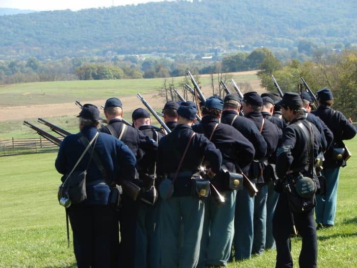 Members of the 8th Ohio Volunteers Living History Association Prime their muskets and come to the Ready position