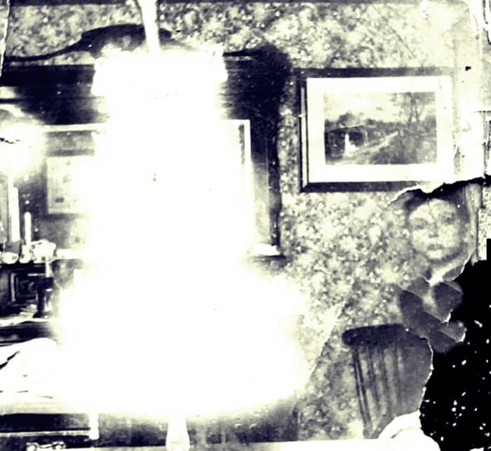 An early photo of my grandad, just visible on the right, with a wedding cake. It would have been the wedding of one of his older siblings.
