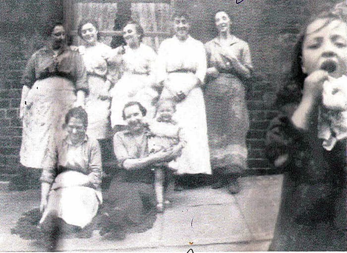 Grandad's mum Annie (standing in the centre) and her sister Mary (standing on the right) with their neighbours in Hunslet Carr around the time of World War One.