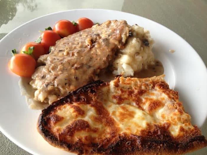 The finished dinner. Cube Steak with mushroom gravy, mashed potatoes, tomato with basil and cheese garlic bread.