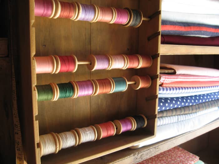 At the general store, Acadians could buy thread of different colors and patterned cotton fabric. Many Acadians lived in isolated communities with limited access to goods like these.