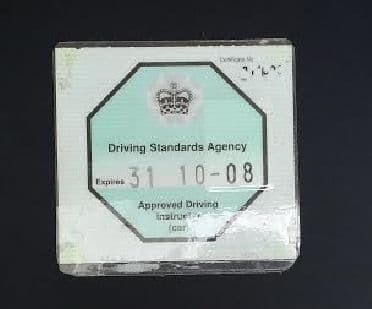 Fully qualified Approved Driving Instructors (ADIs) display a green octagonal badge