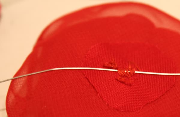 Since the material was pretty flimsy, I added a small circle of a stronger material to the back when I stitched all the petals together. This extra piece of material also helped when I sewed the floral wire to the back--it just seemed to give the fl