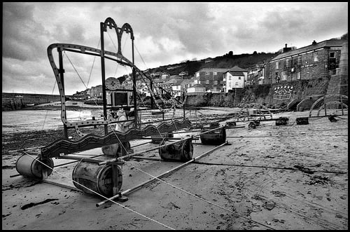 Preparing for the Light Show at Mousehole Beach showing the Lighted Star Gazy Pie on the cliff front and a floating Dragon