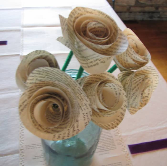 My niece, a librarian, had a book themed wedding, since she is a librarian. The runners down the center of the tables were book pages with artful edges (scrapbooking technique) and she made roses from book pages for centerpieces.