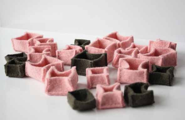 These tiny sweater boxes are for storing and partitioning a jewelry collection so that delicate earrings don't get scratched, and necklace chains don't get tangled - clever!