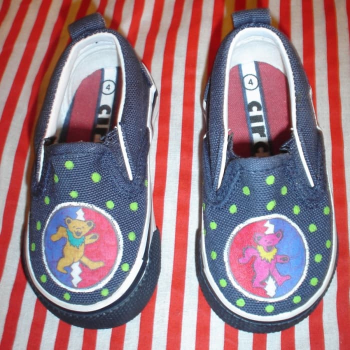 A pair of GD baby shoes made from recycled thrift store shoes, acrylic paint, and the method listed below.