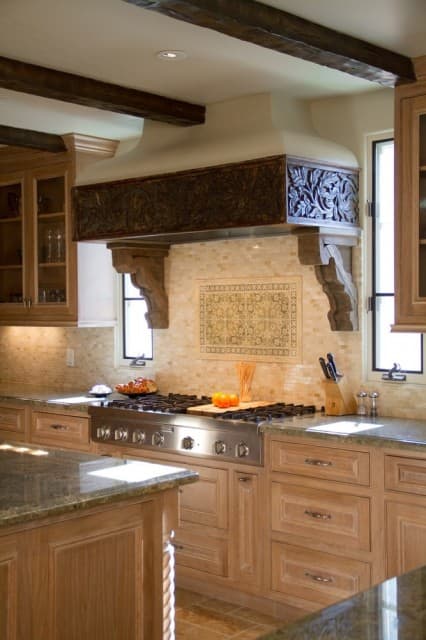 Beautiful carved wood kitchen hood with wood ceiling beams