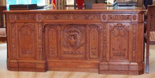 The panel face of the Resolute Desk, given to the United States by Queen Victoria. Presidents have used it off and on since then. President Clinton brought it back into the Oval Office and has been used by the presidents since then.