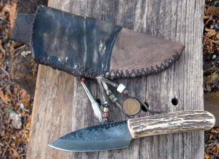 Vintage style frontier knife. Brain tan and aged leather belt sheath with vintage trade beads, Antiqued hand forged stag knife with patina aged blade.