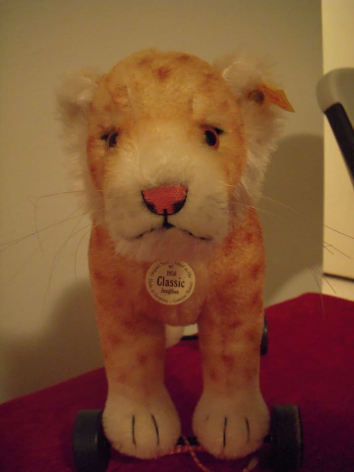 This cat-on-wheels Steiff has a white pendant and yellow ear tag. It's a replica of an older Steiff toy, but of unlimited run.