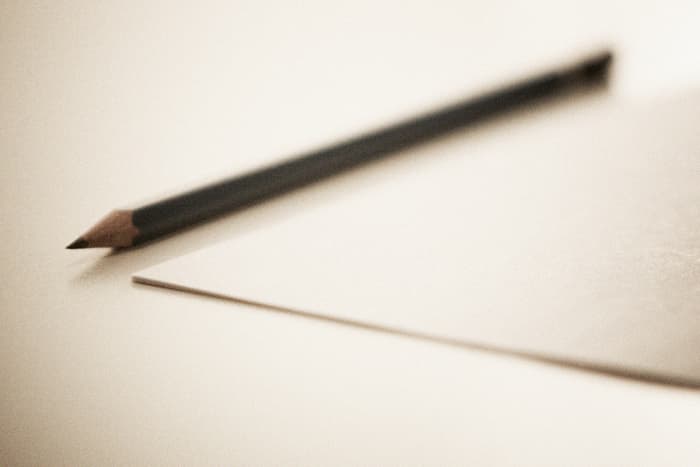 Sharpened Pencil next to a sheet paper, that is what you need to start playing. Image By Thomaseagle (Own work)