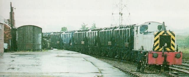At Layerthorpe on the Derwent Valley Light Railway near York, an ex-ROD diesel shunter brings a train of bulk grain wagons for onward transit to distilleries in Scotland or cereal process (food products)
