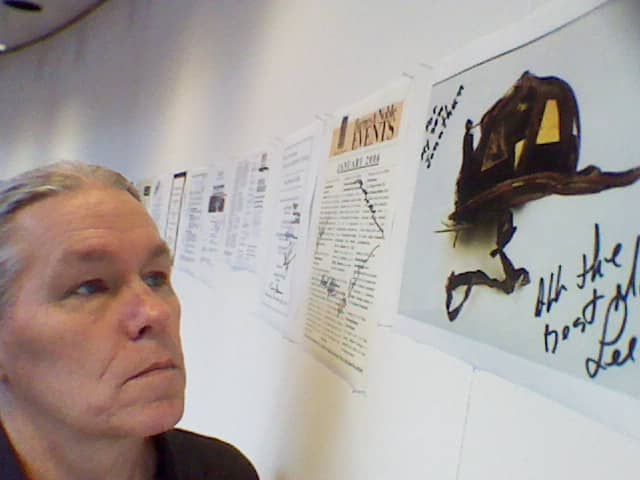 Me, gazing at one of those favorite pieces, a postcard signed by retired firefighter Lee Ielpi at the opening of the WTC Tribute Visitor Center. Pictured is the helmet of his son who perished on 9/11.