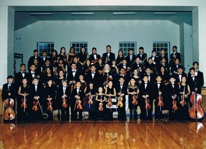After securing the autograph of conductor Anna Heifetz (center), she gave me a few photos of the Ambassadors of Peace Youth Orchestra. One is shown here.