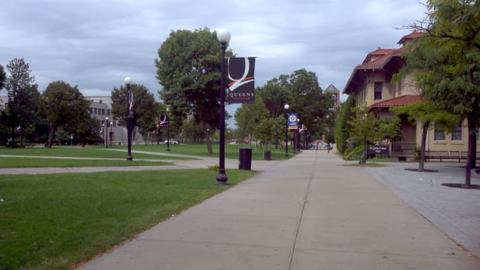 An image of the Queens College campus in Flushing. The Quad to the left and the library straight ahead beyond the trees.