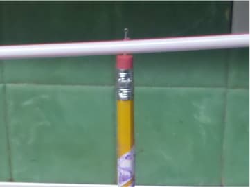 See how the pin goes through the straws and into the top of the eraser? You may need to slide the straws up and down on the pin a few times to widen the whole - so the arrow and tail can spin freely.