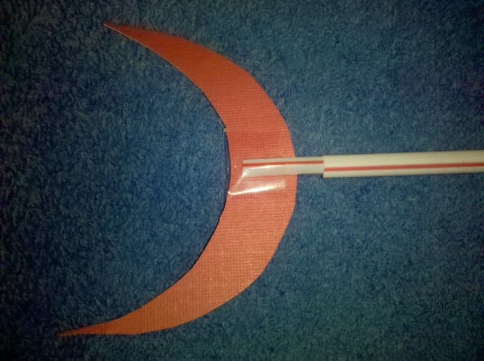 If you look closely you can see how the one straw is sitting inside the other. You can also see how the longer straw has a slit to hold the tail. Our tail would not stay on without tape.
