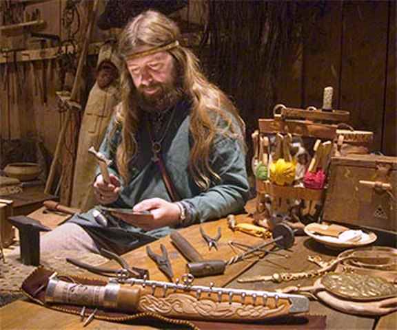 Modern-day weapon-maker, a master craftsman in his workshop busies himself with a task to reproduce a Viking Age sword