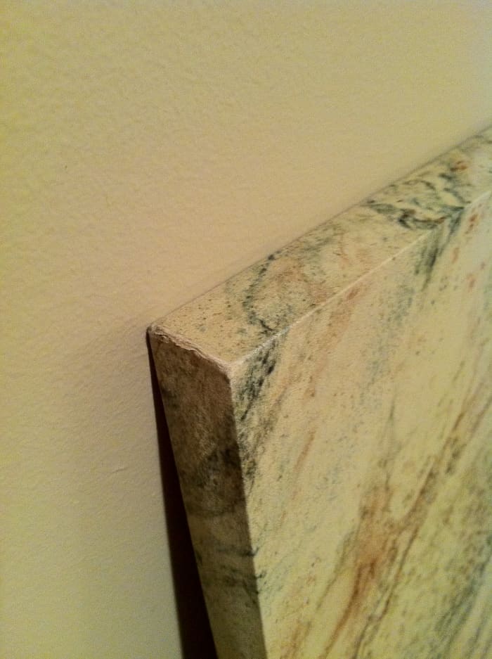 The corner of a much-used coffee table with over a decade of people brushing past it--not bad!