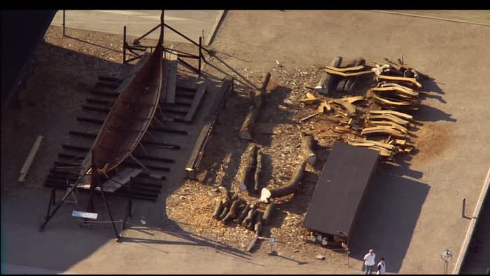 Aerial view looking down on the Viking shipyard, Roskilde Museum, Denmark with stored timbers and a ship awaiting completion on the stocks