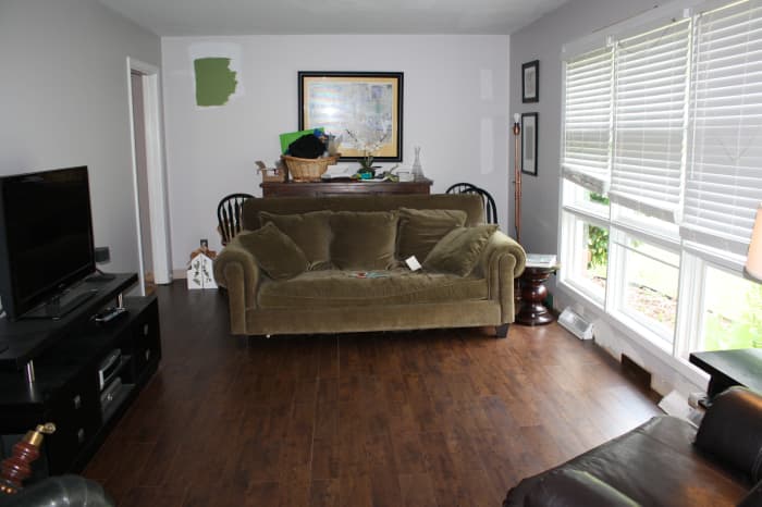 Our living room sans rug so you can really see the floor! Please ignore the paint test in back left of picture.