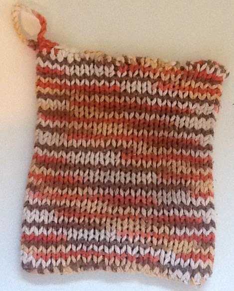 This is a loom knit potholder that is great for beginning knitters. It has a crocheted loop for hanging.