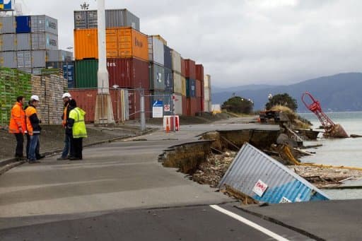 An empty shipping container sits in the harbour where the land fell into the sea, on July 22, 2013 (AFP, Marty Melville)