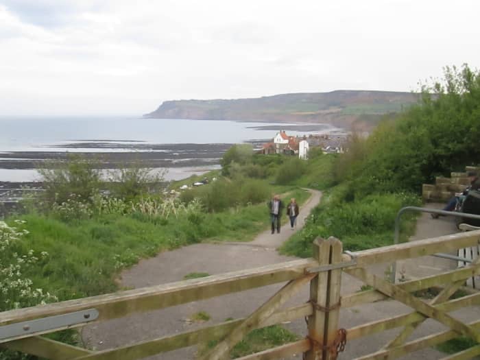 Park at the old station site, walk down past more recent hotels and housing. A new wall was built in the 70s to shore up the cliff that the 'road' to the left descended. It's a footpath now, that leaves the course of a road that leads nowhere.