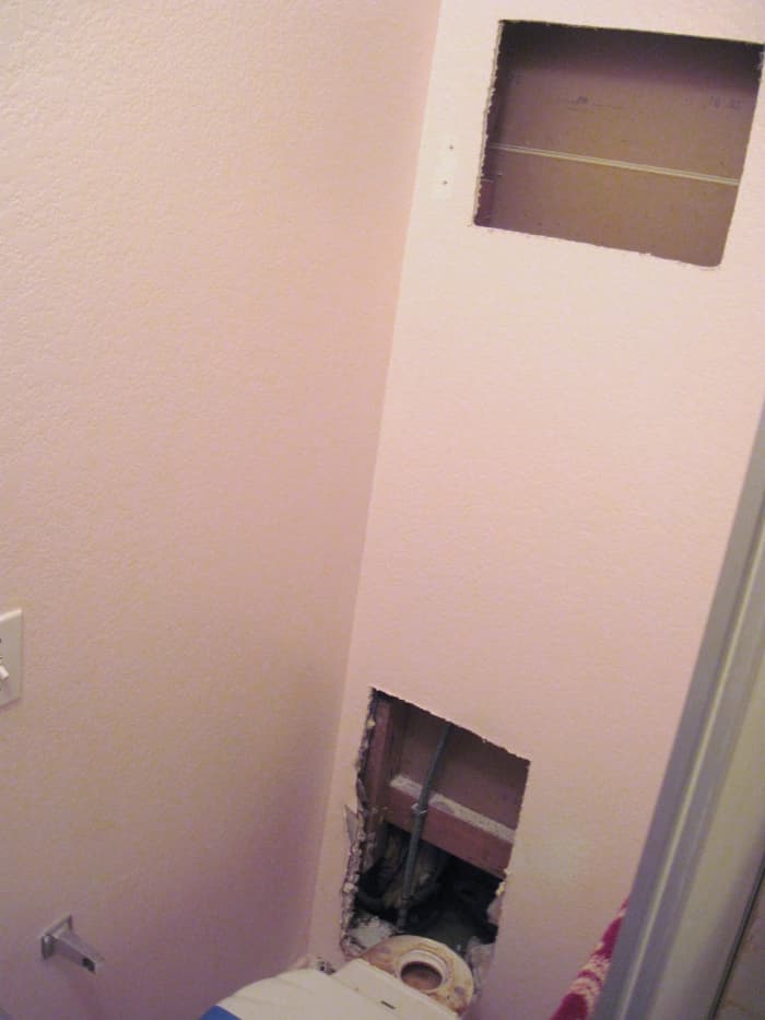 Two holes had to be cut into the wall before the leaking water pipe was found.