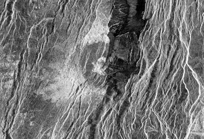 The fractured Somerville Crater on Beta Regio. Disruption of the crater by this fracturing can only have occurred subsequent to the meteor impact, and must therefore be more recent than any global resurfacing event