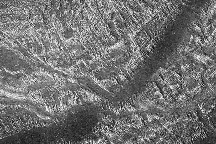 Ovda Regio is one of the highland regions, characterised by lava channels (the dark area across the centre) and numerous ridges and valleys - there can be no better evidence of considerable deformation of the surface in the past