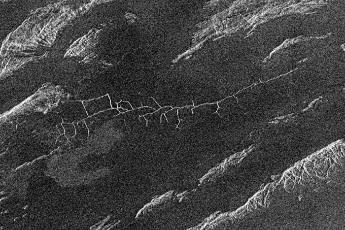 This is a 105 kim (63 mile) wide region of Aphrodite Terra. The central feature looks for all the world like a river valley - except for the extreme angular intersections which rather suggest cracking of the surface under pressure and seepage of lava