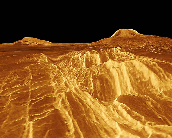 Two great shield volcanoes in Western Eistla Regio. Sif Mons (on the left) rises 2 km (1.2 miles) above the plain, and Gula Mons (on the right) is 3 km (1.8 miles) high.The distance between Sif Mons and Gula Mons is about 730 km (450 miles).