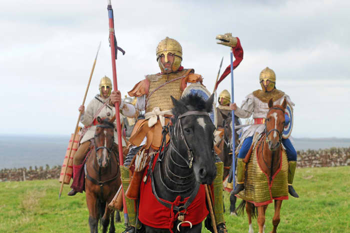 Romano-Britons with vestiges of Roman military uniform and helmets - would Arthur have looked like this character in the lead?