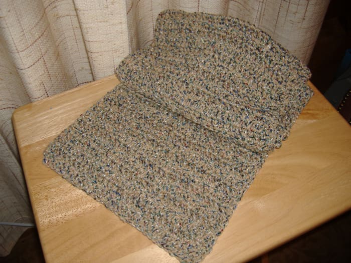 This scarf was made using a yarn that is solid with a tiny ribbon woven into it. It is called "Fiesta" yarn, by Red Heart. It is no longer available.