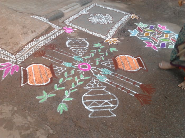 I took this picture very early in the morning while the lady of the house was drawing this festive rangoli. The unfinished design shows earthern pots with rice being cooked and sugar canes, which are part of every Pongal celebrations.