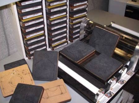 A traditional die-cutting machine. Cuts are done manually and each die plates needs its own storage space. Over the years, that's a lot of space to carve out.