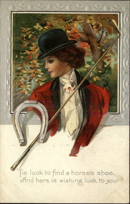 Greeting Card with Woman in Red Riding Jacket and horseshoe and riding whip and saying Tis luck to find a horse and here wishing luck to you