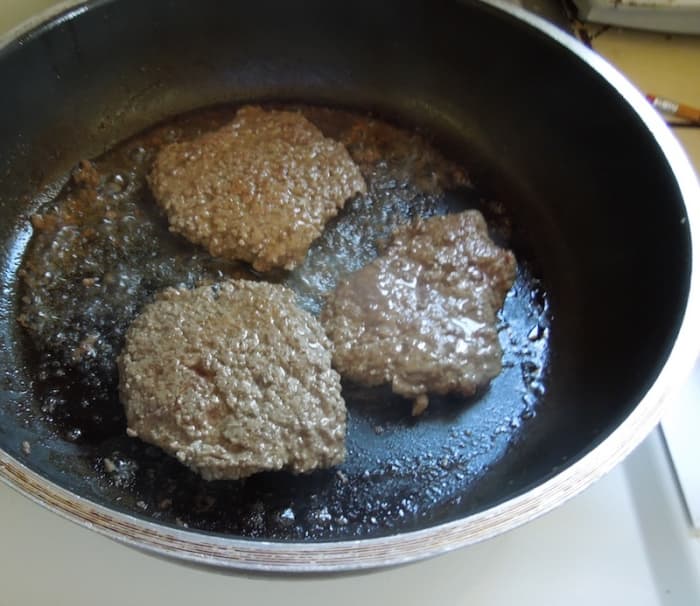 I have removed one steak that was done first. Now you can see that the others are done, too, because the juices are clear and the steaks have shrunk a lot.