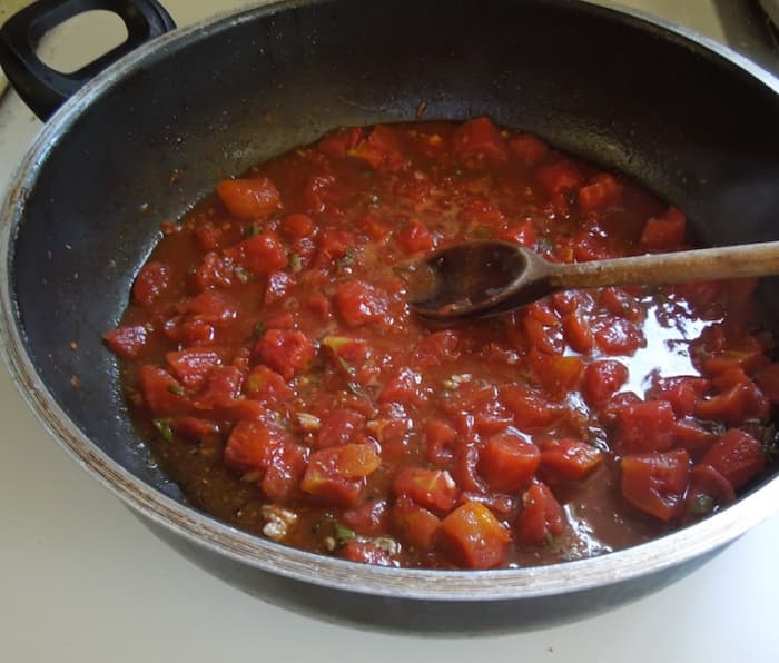 Cook and stir over medium-high heat. Mixture should be boiling. As it cooks it will thicken and lose liquid.