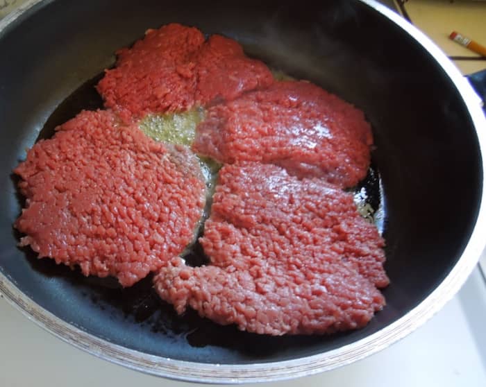 Put steaks in hot oil and cook until juices run clear, about three minutes on each side. Sprinkle with salt when you put steaks in pan and again when you turn them over. Notice the size of the raw steaks and how close they are to the edges of pan