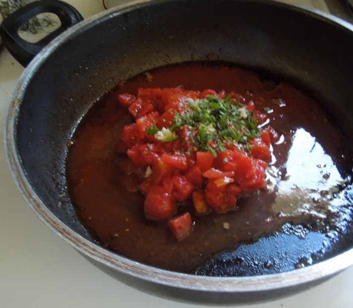 Put canned tomatoes and herbs in skillet with pan juices that remain.