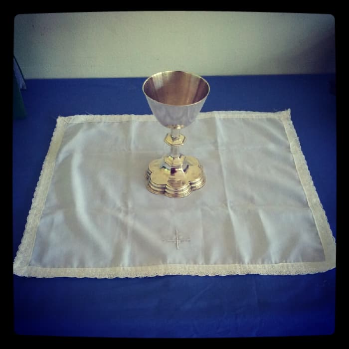 Step 2: Place the Celebrant's Chalice in the centre of the Corporal. If there is a Cross, the Cross should face the Celebrant
