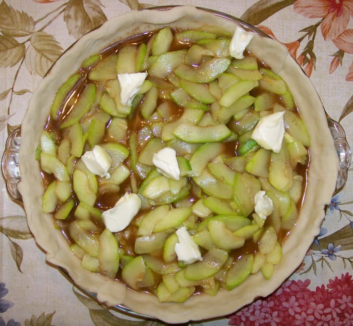 All ingredients except butter mixed and spread onto bottom crust. Butter pieces scattered on top.