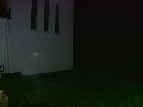 In the lower left hand side of the picture, there's a strange mist which seems to be emitting its own light. The concentration of light at the top of the figure could indicate an entity trying to manifest into the physical world.